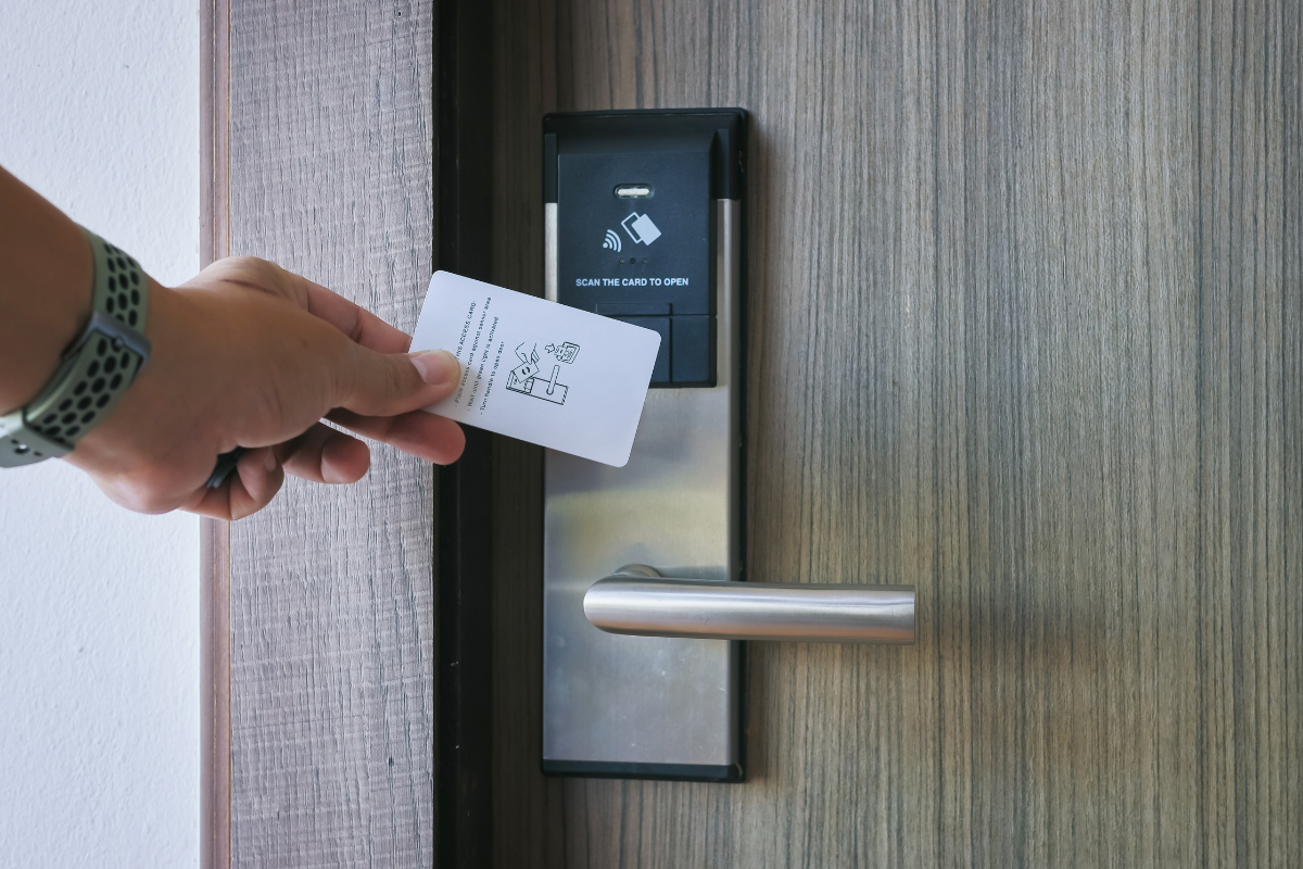 una persona abriendo la puerta de un hotel mediante tarjeta electrónica